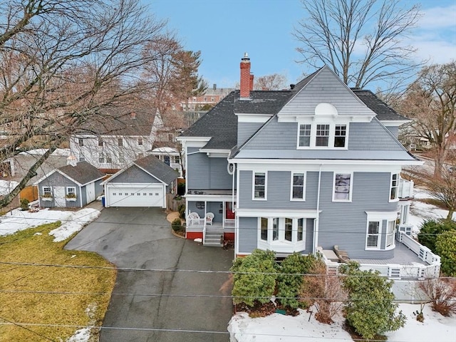 view of front of house with a porch, fence, roof with shingles, and a chimney