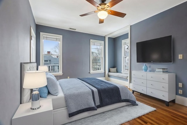 bedroom featuring visible vents, ceiling fan, and wood finished floors