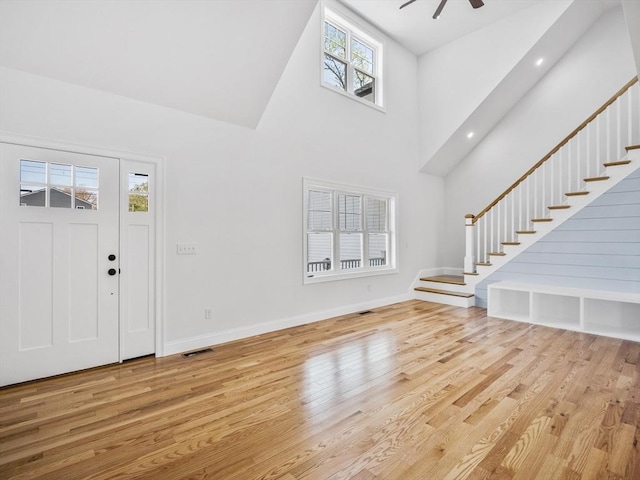 310 Old Westport, Dartmouth, MA 02747 - entryway featuring a towering ceiling, wood finished floors, stairway, baseboards, and ceiling fan