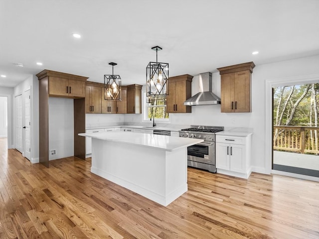 310 Old Westport, Dartmouth, MA 02747 - kitchen featuring wall chimney range hood, appliances with stainless steel finishes, a sink, light countertops, and light wood-style floors