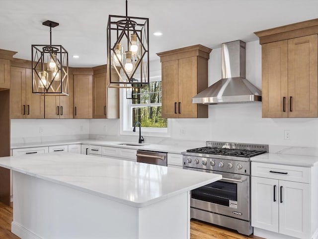 310 Old Westport, Dartmouth, MA 02747 - kitchen featuring wall chimney range hood, appliances with stainless steel finishes, a sink, light wood finished floors, and light stone counters