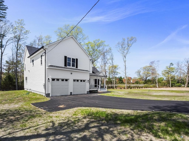 310 Old Westport, Dartmouth, MA 02747 - view of side of home featuring asphalt driveway, an attached garage, a yard, and a porch