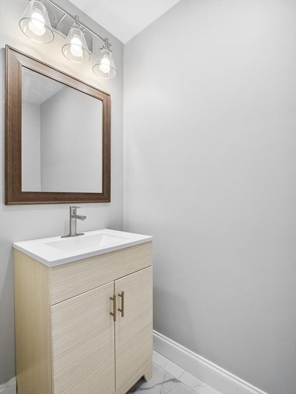 310 Old Westport, Dartmouth, MA 02747 - bathroom with marble look tile flooring, baseboards, and vanity