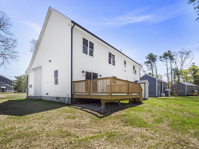 310 Old Westport, Dartmouth, MA 02747 - rear view of house featuring a wooden deck, a lawn, and an outbuilding