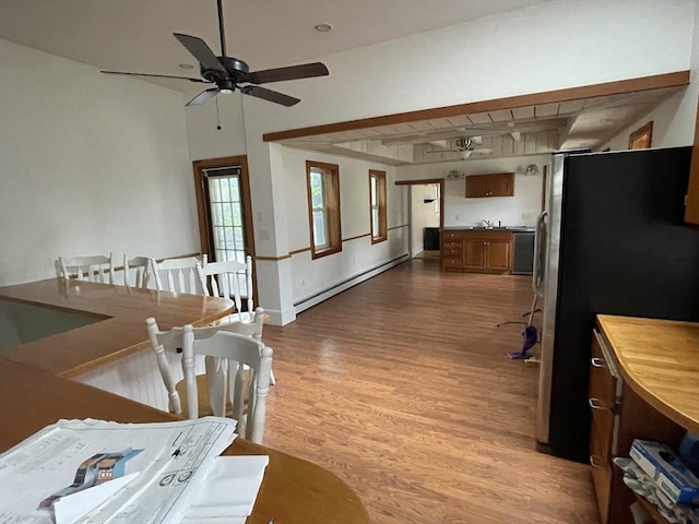 20 Cross St, Salem, MA 01970 - kitchen featuring baseboard heating, freestanding refrigerator, light wood-style flooring, ceiling fan, and brown cabinets
