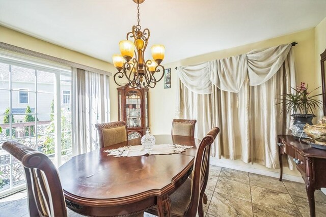 dining space with an inviting chandelier and stone finish flooring