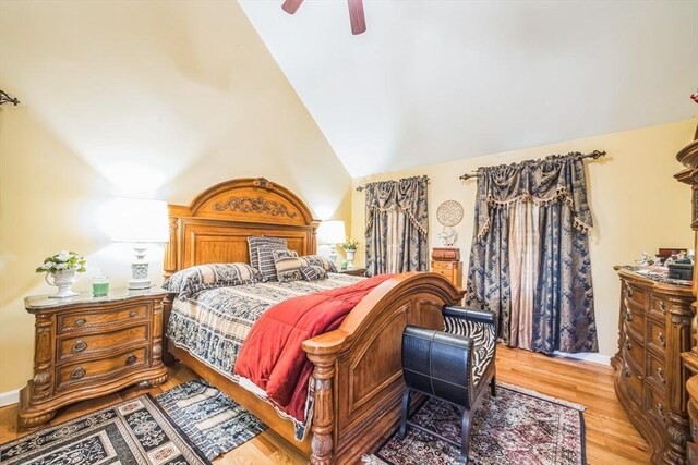 bedroom with light wood-style flooring, ceiling fan, and high vaulted ceiling