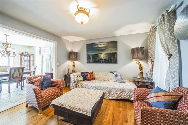 bedroom with a notable chandelier and wood finished floors