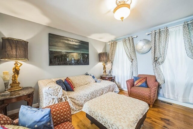 bedroom with visible vents and wood finished floors