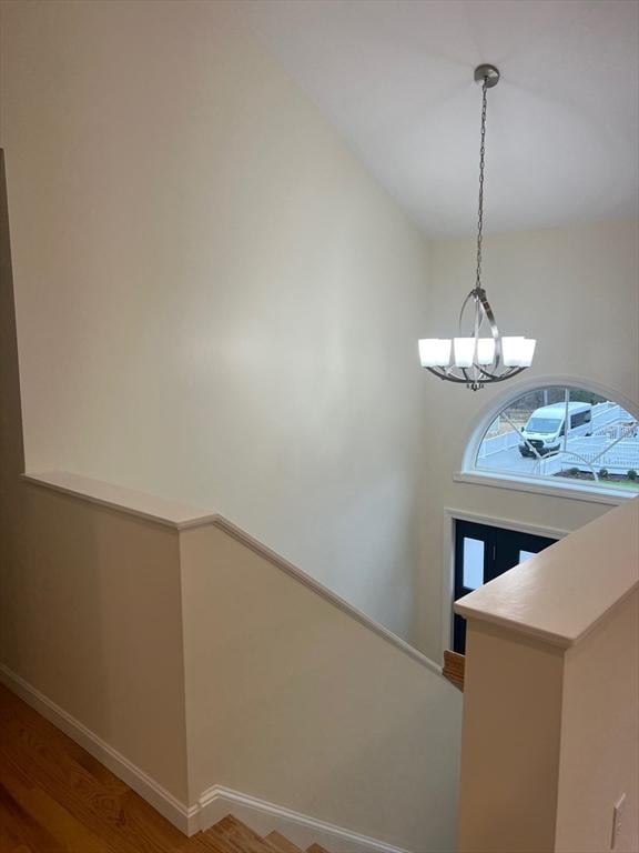 foyer with an inviting chandelier and hardwood / wood-style floors