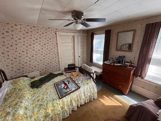 270 Holtshire Rd, Orange, MA 01364 - carpeted bedroom featuring wood walls, ceiling fan, and a closet