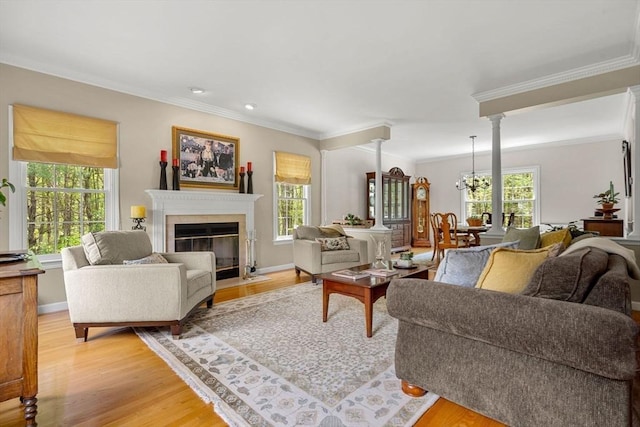 6 Bishop Ln, Middleton, MA 01949 - living area with healthy amount of natural light, crown molding, a fireplace with flush hearth, light wood-style flooring, and baseboards