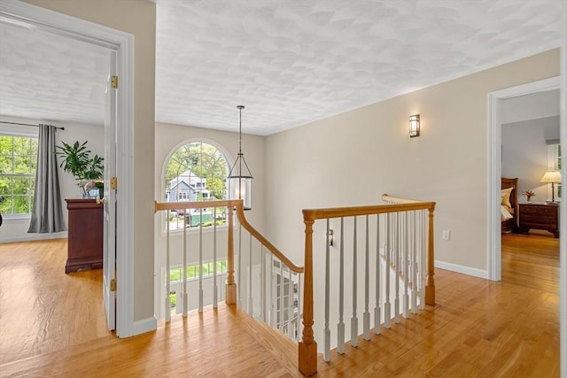 6 Bishop Ln, Middleton, MA 01949 - corridor featuring an upstairs landing, healthy amount of natural light, wood finished floors, and a textured ceiling