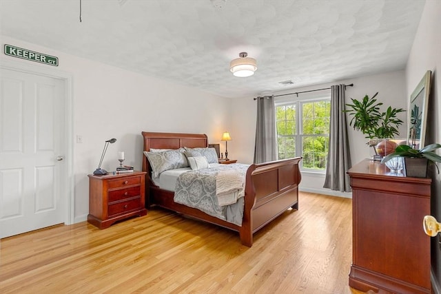 6 Bishop Ln, Middleton, MA 01949 - bedroom featuring light wood-type flooring, a textured ceiling, and baseboards
