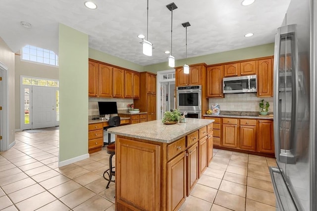 6 Bishop Ln, Middleton, MA 01949 - kitchen with stainless steel appliances, a kitchen island, backsplash, brown cabinetry, and recessed lighting