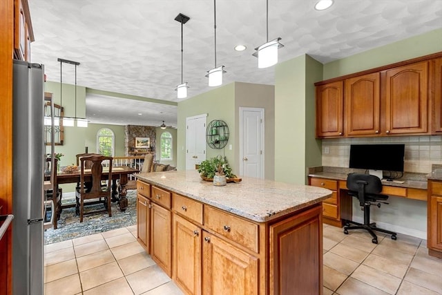 6 Bishop Ln, Middleton, MA 01949 - kitchen featuring freestanding refrigerator, a kitchen island, brown cabinetry, light tile patterned flooring, and recessed lighting