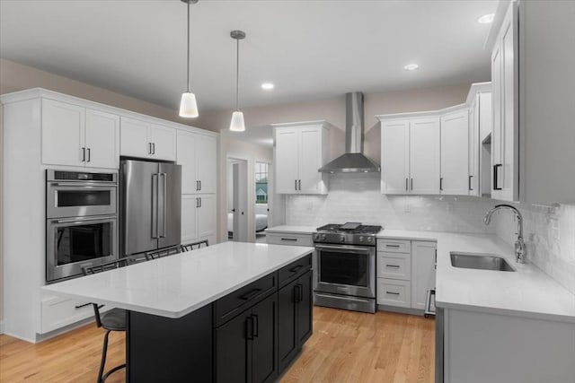 27 Sophia Dr, Rehoboth, MA 02769 - kitchen with appliances with stainless steel finishes, wall chimney range hood, a sink, a center island, and dark cabinetry