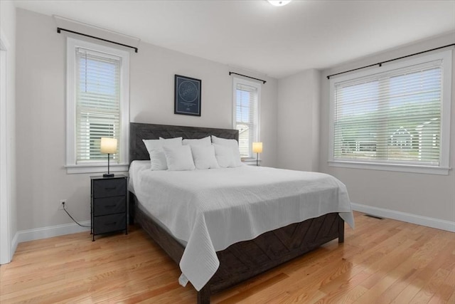 27 Sophia Dr, Rehoboth, MA 02769 - bedroom with light wood finished floors, baseboards, and multiple windows