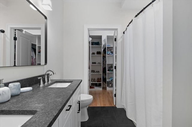 27 Sophia Dr, Rehoboth, MA 02769 - bathroom with a spacious closet, double vanity, tile patterned flooring, toilet, and a shower with curtain