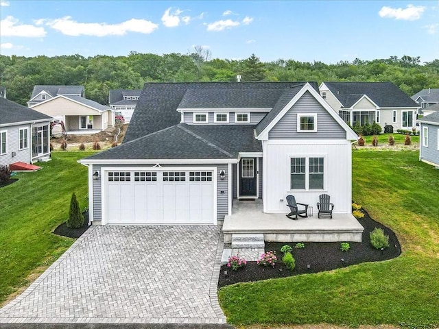 27 Sophia Dr, Rehoboth, MA 02769 - view of front facade with an attached garage, driveway, a front lawn, and board and batten siding