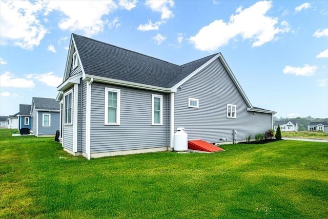 27 Sophia Dr, Rehoboth, MA 02769 - rear view of house with a yard and roof with shingles