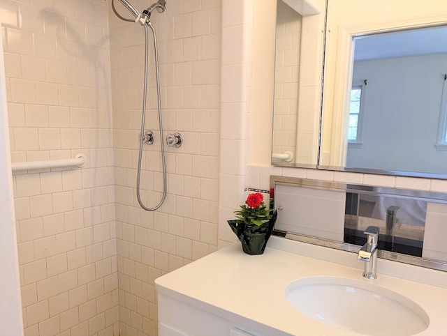 bathroom featuring vanity and tiled shower