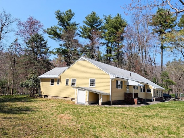 view of side of property with a yard