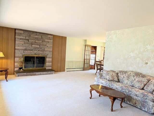 living area with baseboard heating, carpet flooring, and a fireplace