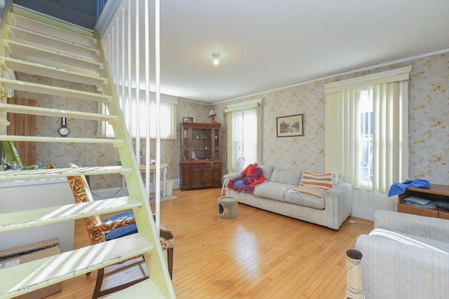 living room featuring ornamental molding, plenty of natural light, and hardwood / wood-style floors