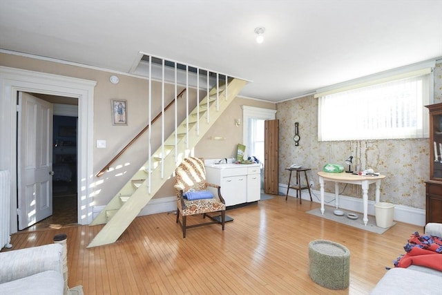 living room featuring hardwood / wood-style flooring and ornamental molding