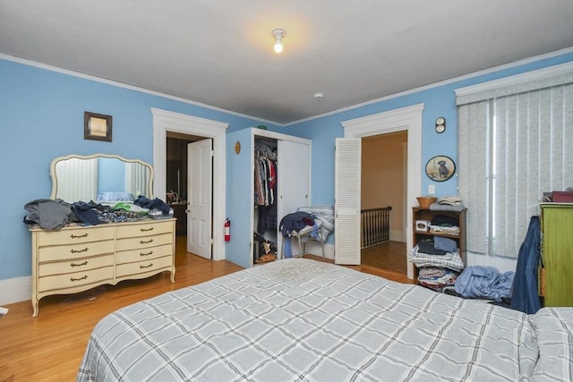 bedroom featuring ornamental molding, hardwood / wood-style floors, and a closet