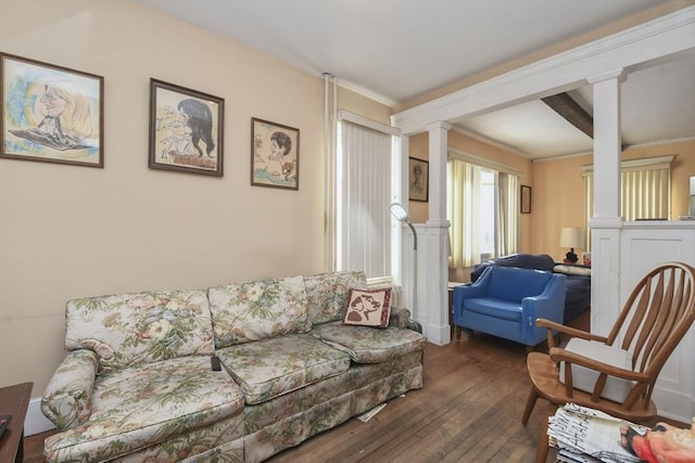 living room featuring ornamental molding, decorative columns, and dark hardwood / wood-style floors