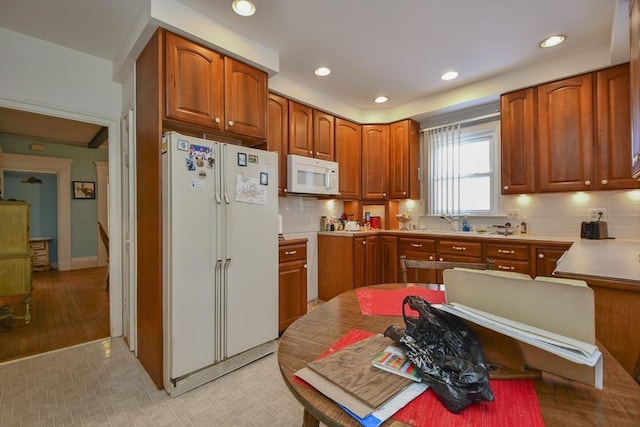 kitchen with white appliances and decorative backsplash