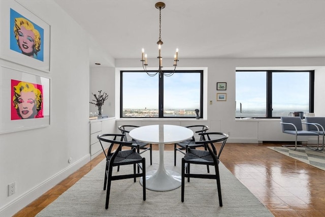 65 E India Unit 27F, Boston, MA 02110 - dining room featuring baseboards, a chandelier, and wood finished floors