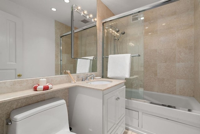 65 E India Unit 27F, Boston, MA 02110 - full bathroom featuring combined bath / shower with glass door, vanity, toilet, and recessed lighting