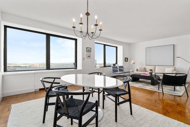 65 E India Unit 27F, Boston, MA 02110 - dining area with a chandelier and baseboards