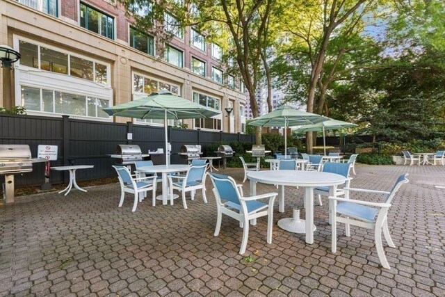65 E India Unit 27F, Boston, MA 02110 - view of patio / terrace featuring outdoor dining space, area for grilling, and fence