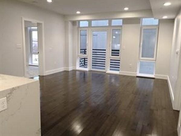262 Monsignor Obrien Hwy Unit 503, Cambridge, MA 02141 - unfurnished living room featuring wood finished floors and recessed lighting