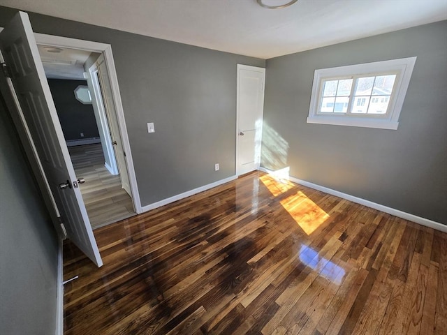 unfurnished bedroom with dark hardwood / wood-style floors