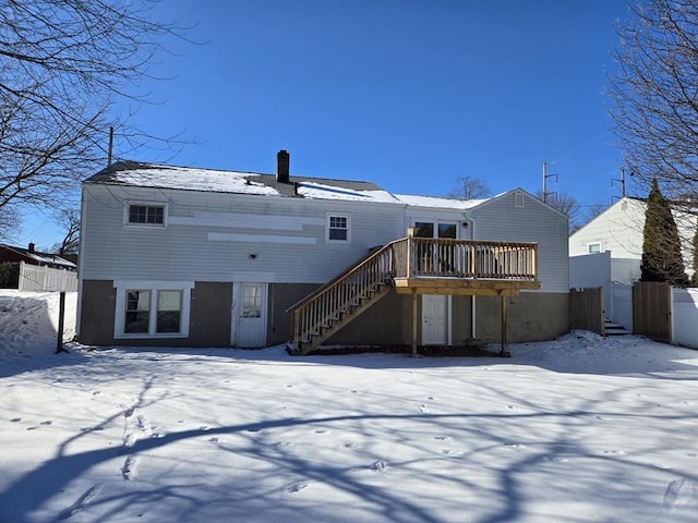 snow covered property featuring a wooden deck