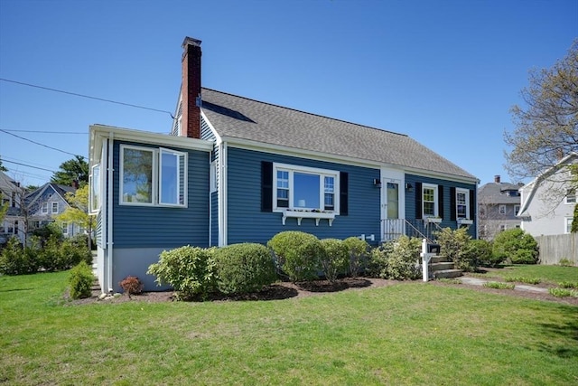 242 Furnace Brook Pkwy, Quincy, MA 02169 - view of front of home with a front yard and a chimney