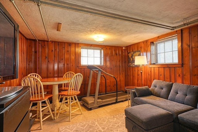 242 Furnace Brook Pkwy, Quincy, MA 02169 - sitting room featuring light flooring, wooden walls, and a textured ceiling