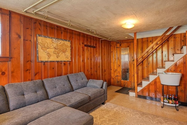 242 Furnace Brook Pkwy, Quincy, MA 02169 - living area featuring wood walls, stairs, light flooring, and a textured ceiling