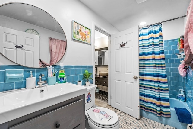 full bathroom featuring vanity, tile patterned flooring, toilet, tile walls, and shower / tub combo with curtain