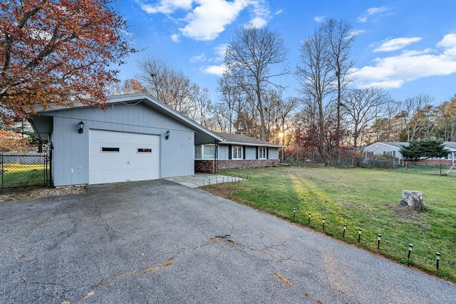 view of side of property with a garage and a yard