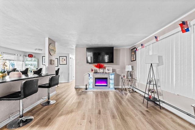 living room featuring light hardwood / wood-style floors and baseboard heating