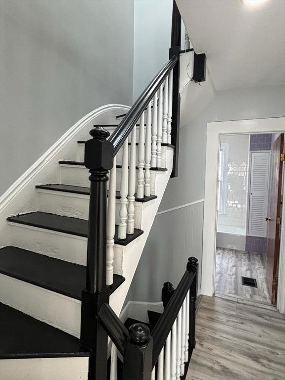 stairway with hardwood / wood-style flooring