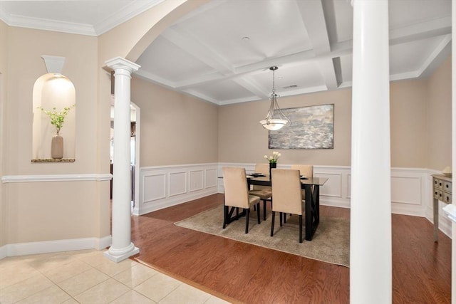 dining area featuring coffered ceiling, ornate columns, ornamental molding, light tile patterned floors, and beam ceiling