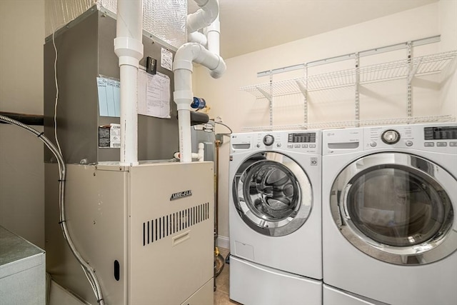 washroom featuring separate washer and dryer and heating unit