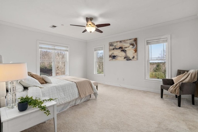 carpeted bedroom featuring ceiling fan and crown molding